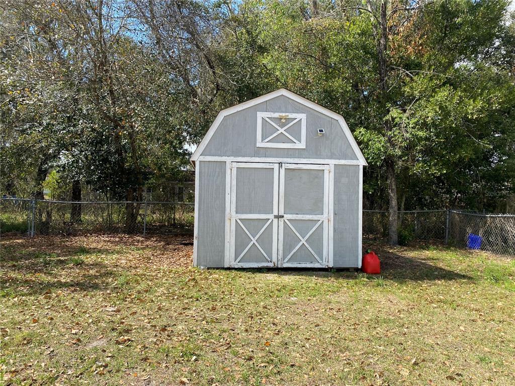 39656 Meadowood Loop Zephyrhills, FL 33542 - Photo 25 of 30 a view of backyard with small cabin