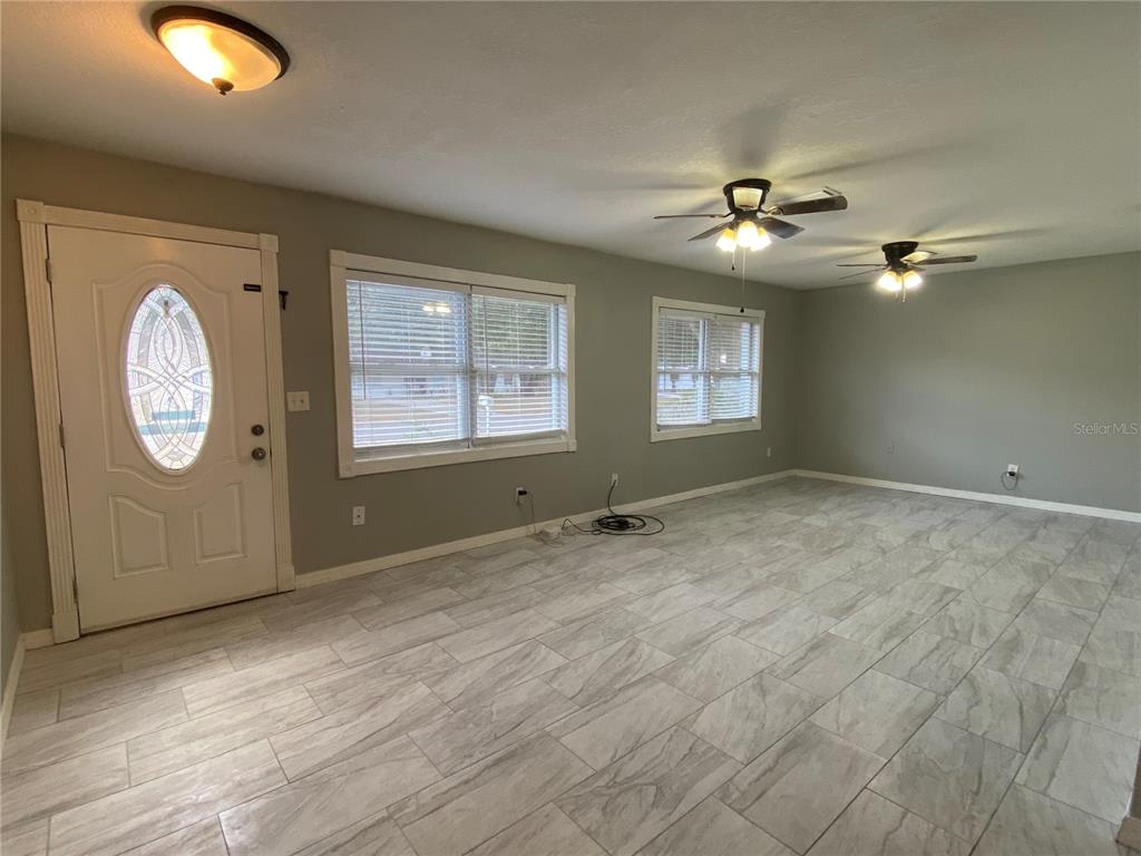 39656 Meadowood Loop Zephyrhills, FL 33542 - Photo 4 of 30 a view of an empty room with window closet area and ceiling fan