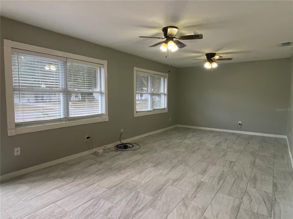 39656 Meadowood Loop Zephyrhills, FL 33542 - Photo 6 of 30 a view of room with a ceiling fan and window