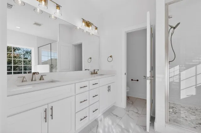 a bathroom with a shower and a sink