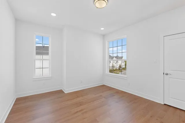a bathroom with a double vanity sink toilet and mirror