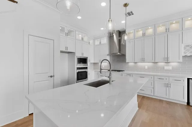 a view of a kitchen with a sink and a wooden floor