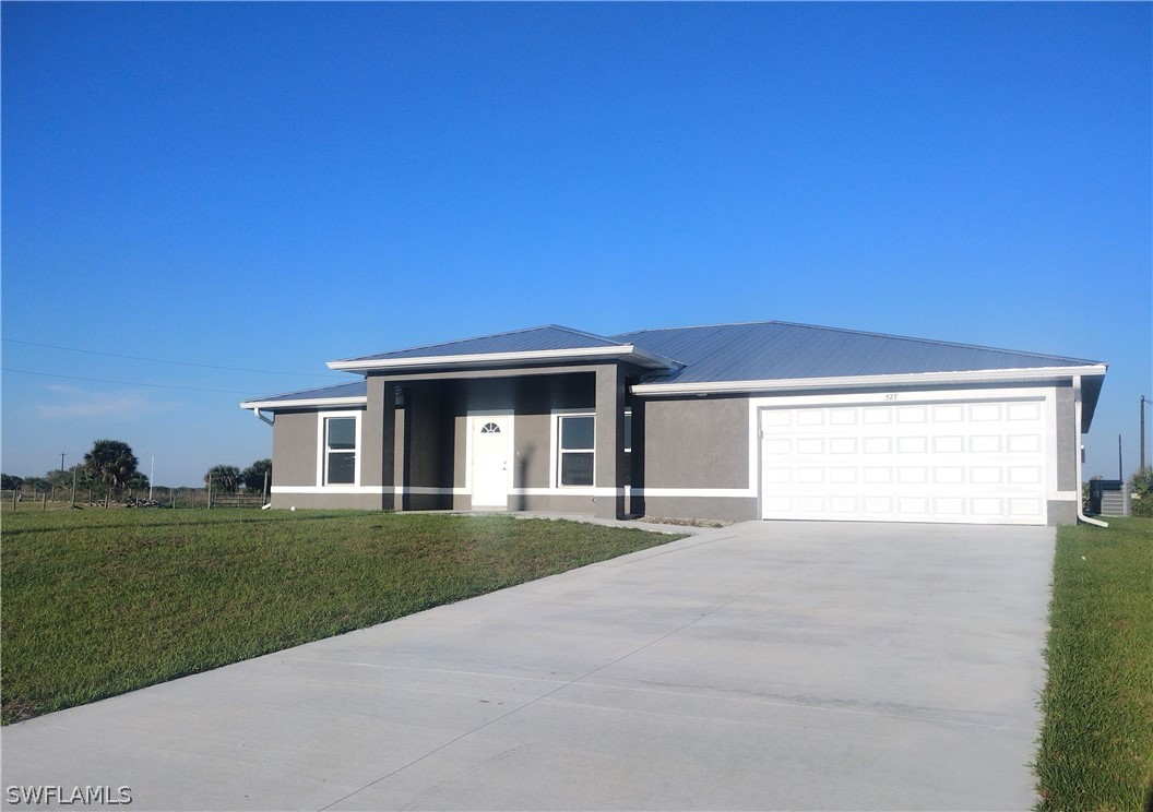 a front view of a house with a yard and garage