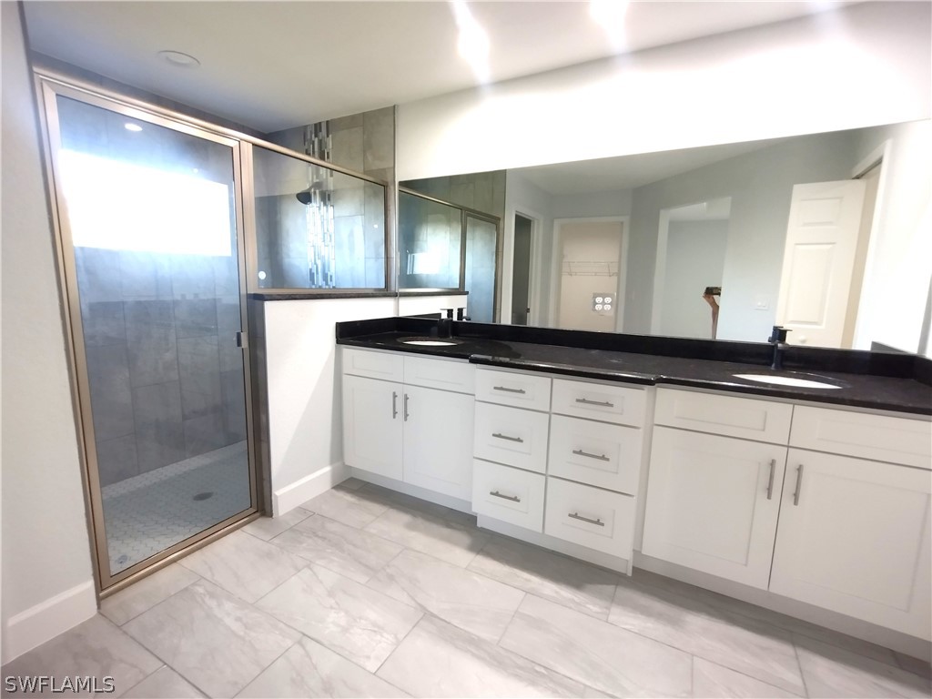 527 David Circle LaBelle, FL 33935 - Photo 12 of 35 a spacious bathroom with a granite countertop sink mirror and double