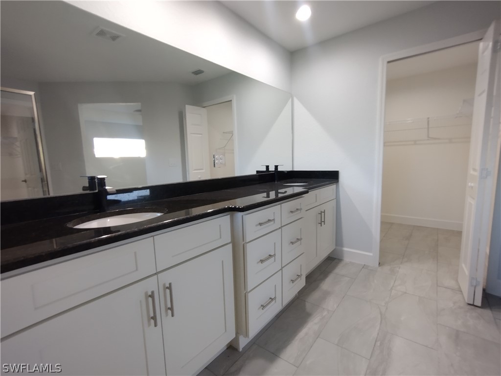 527 David Circle LaBelle, FL 33935 - Photo 14 of 35 a kitchen with granite countertop white cabinets and sink