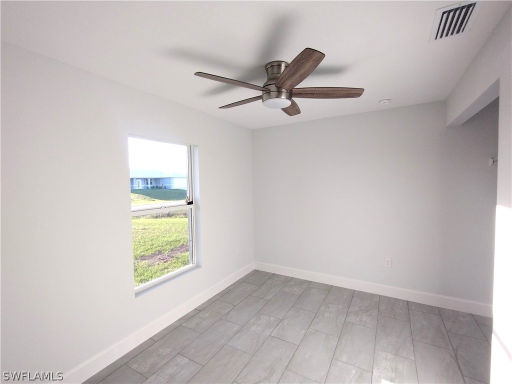 527 David Circle LaBelle, FL 33935 - Photo 21 of 35 an empty room with a window and a ceiling fan