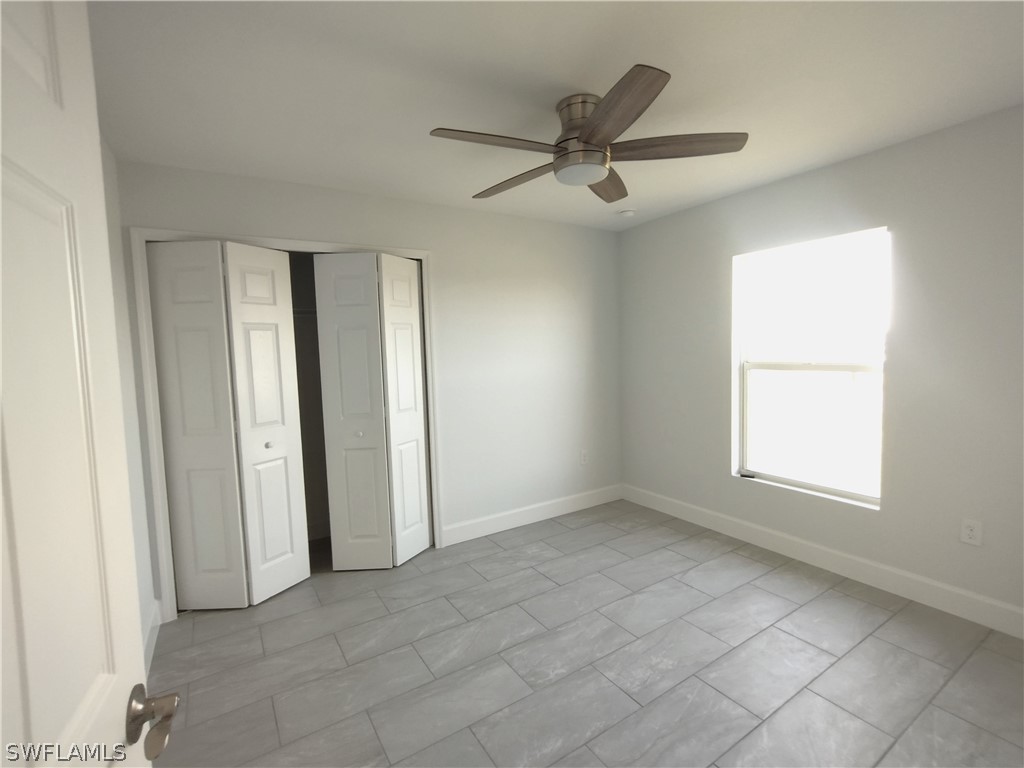 527 David Circle LaBelle, FL 33935 - Photo 22 of 35 an empty room with windows and fan