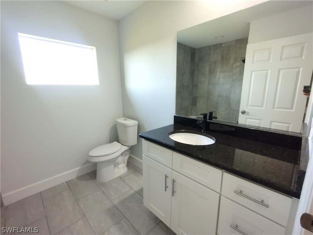 527 David Circle LaBelle, FL 33935 - Photo 23 of 35 a bathroom with a granite countertop sink and a toilet