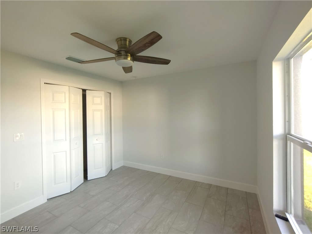 527 David Circle LaBelle, FL 33935 - Photo 27 of 35 an empty room with windows and fan