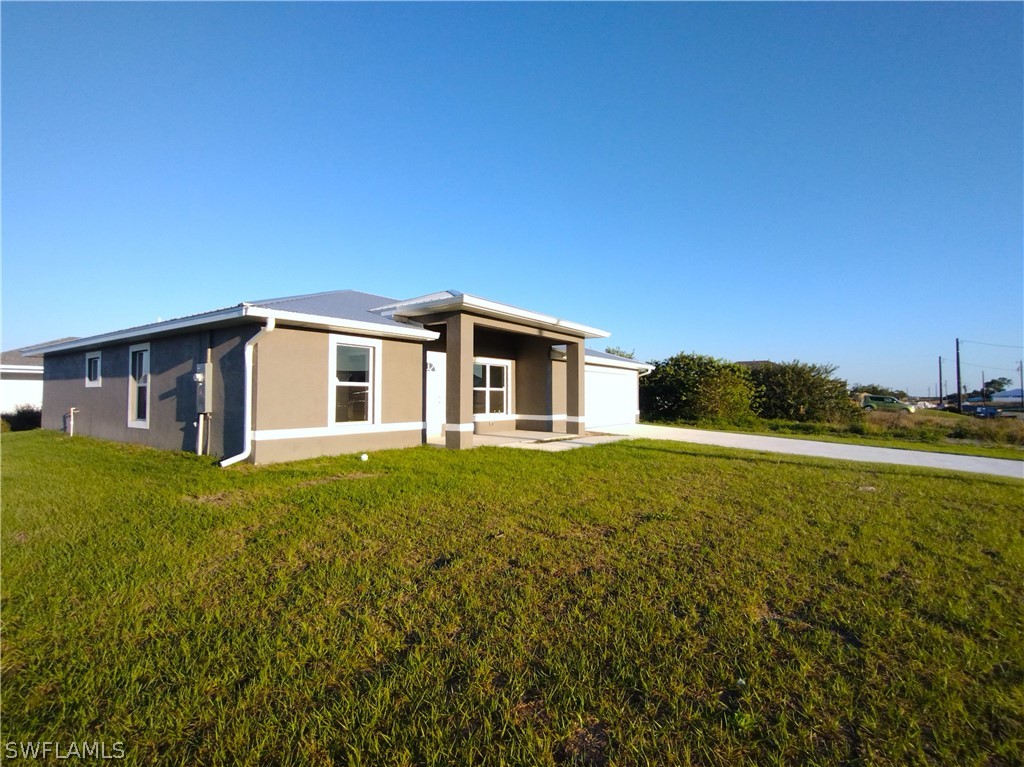 527 David Circle LaBelle, FL 33935 - Photo 34 of 35 a house view with a garden space