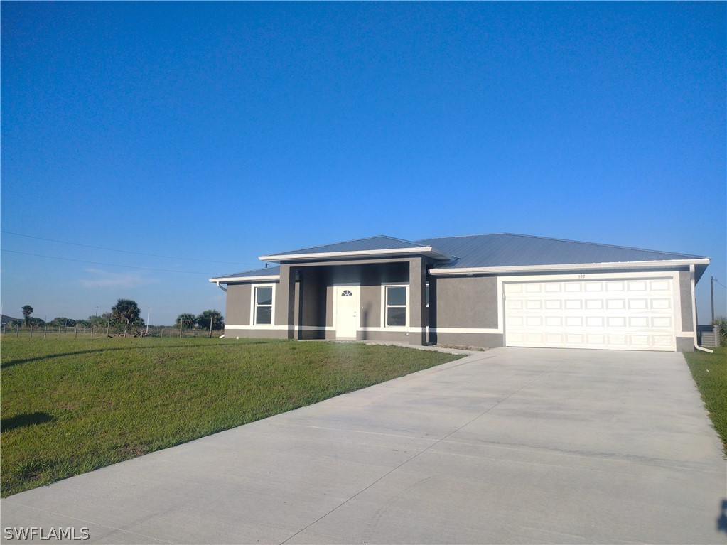 527 David Circle LaBelle, FL 33935 - Photo 35 of 35 a front view of a house with a yard
