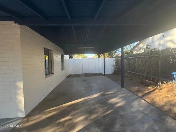 an empty room with closet and windows