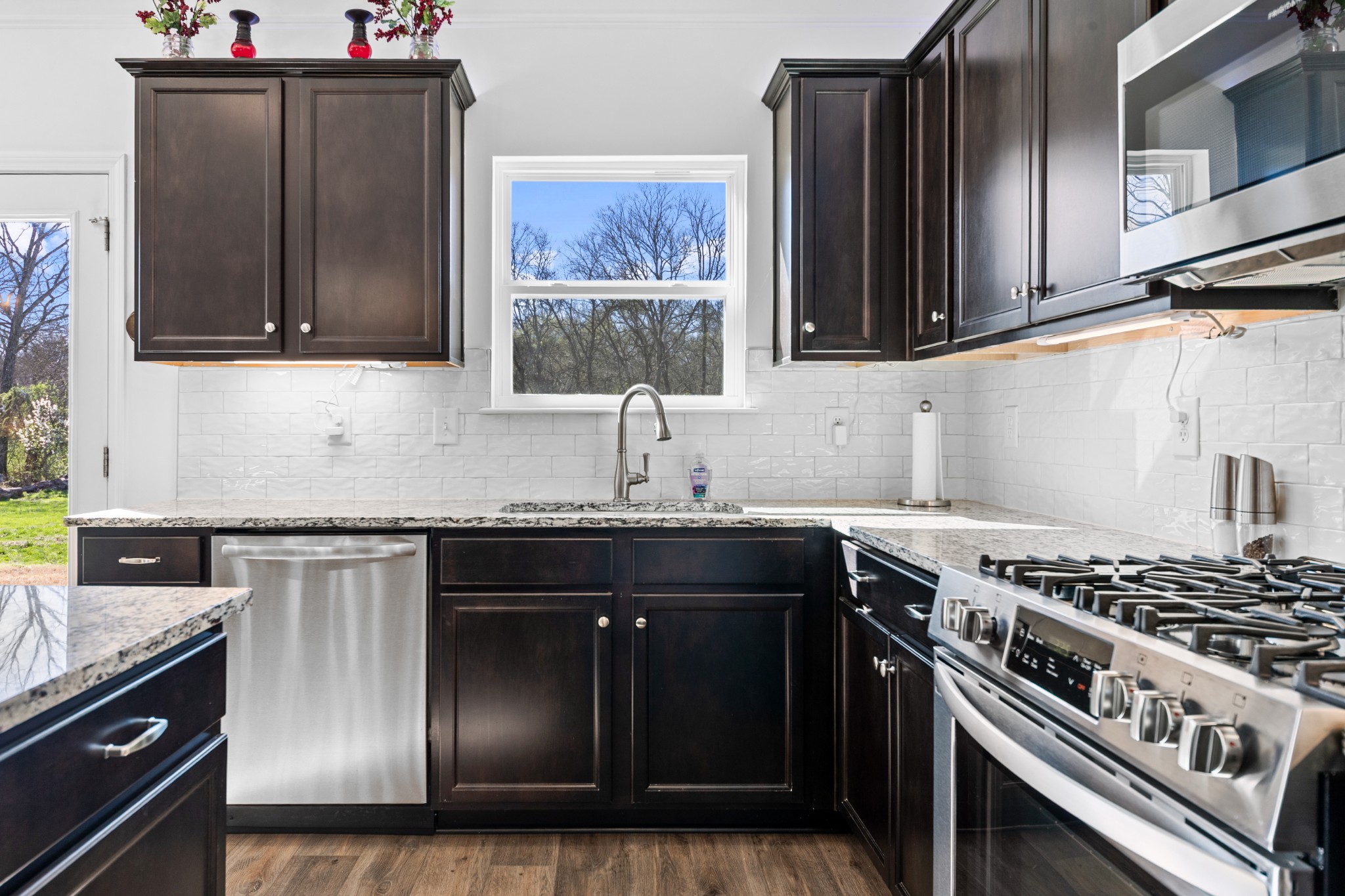 229 Stonewall Road Columbia, TN 38401 - Photo 12 of 61 a kitchen with stainless steel appliances granite countertop a stove and a sink
