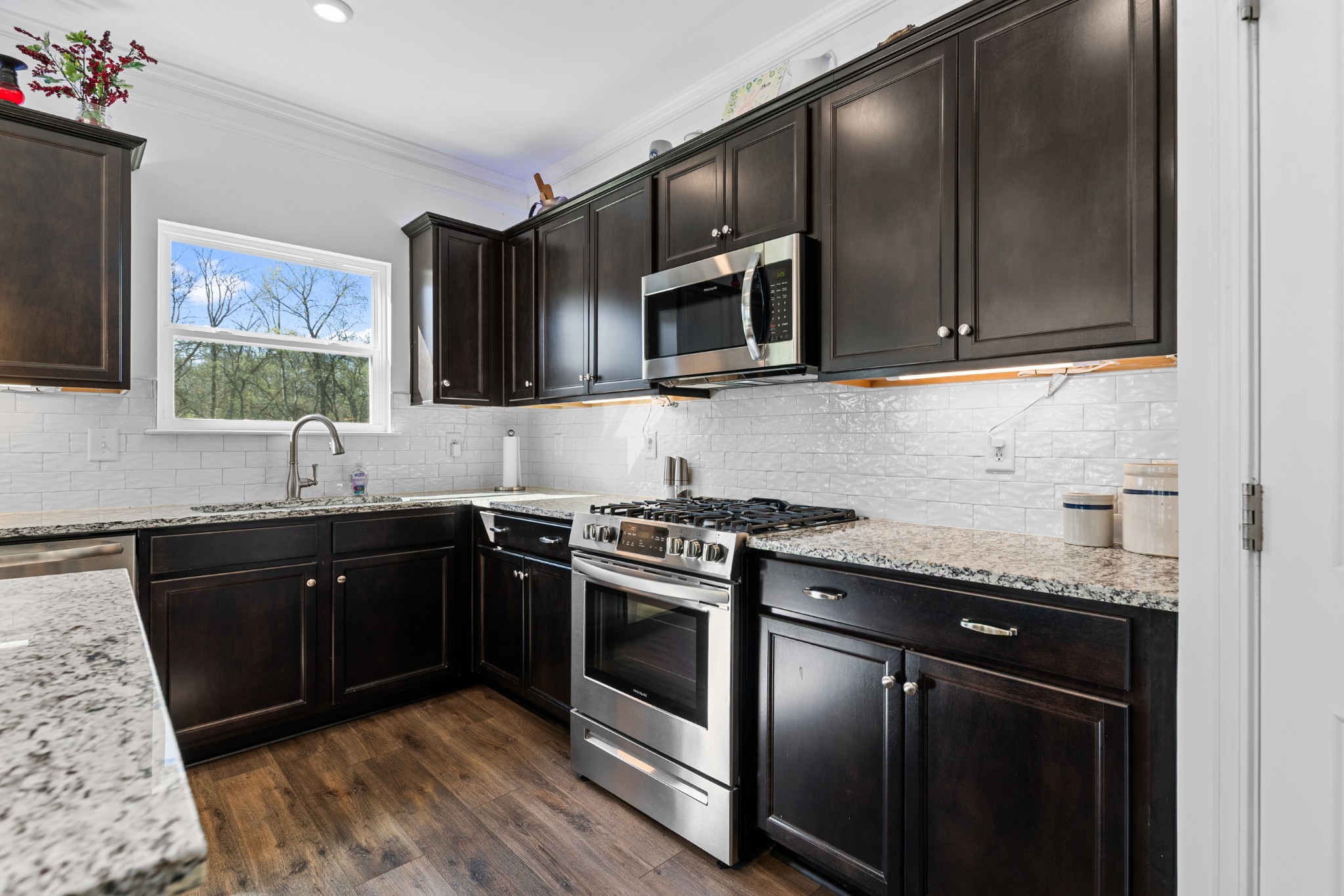 229 Stonewall Road Columbia, TN 38401 - Photo 14 of 61 a kitchen with stainless steel appliances granite countertop a sink stove and microwave