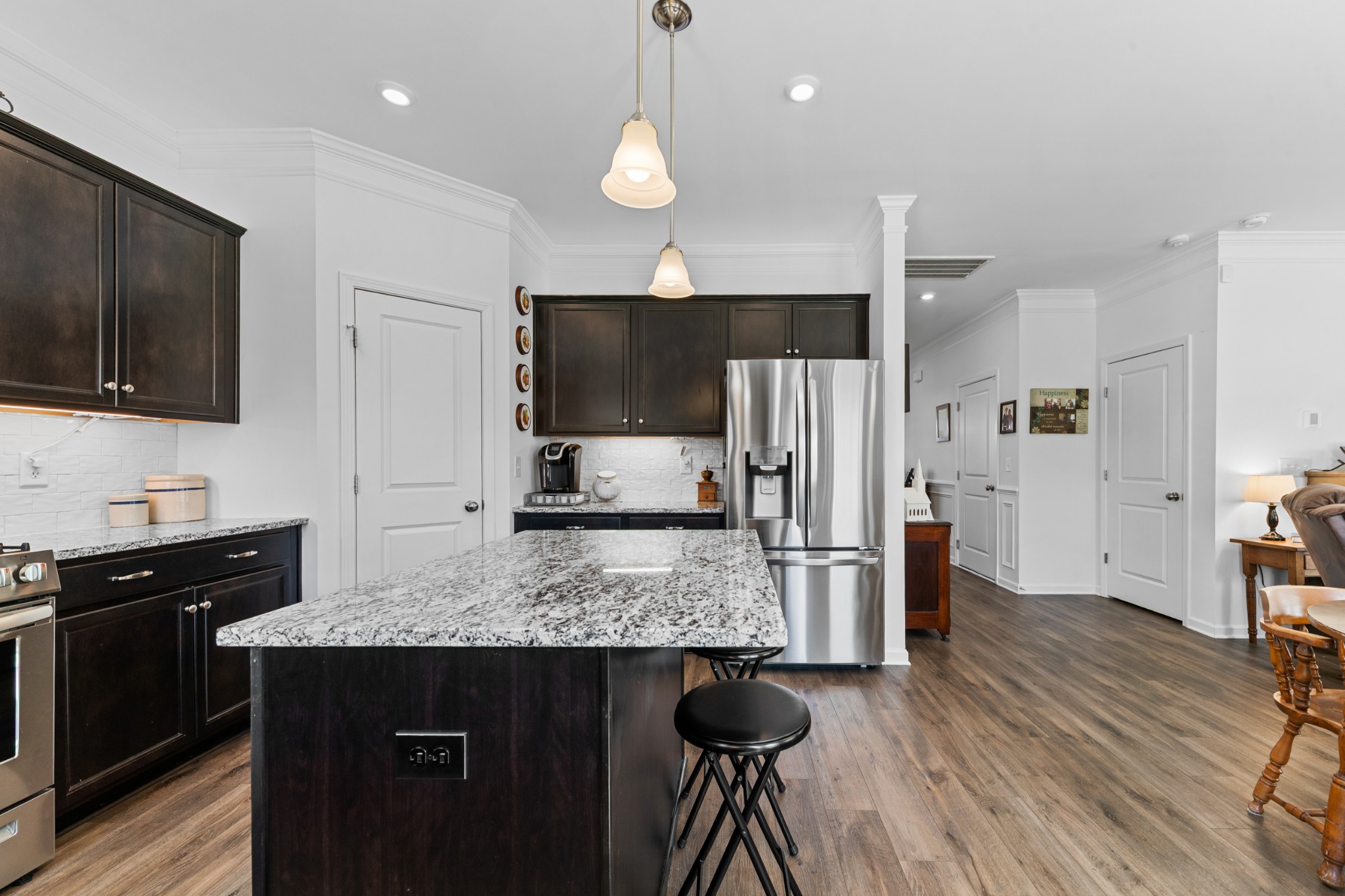 229 Stonewall Road Columbia, TN 38401 - Photo 17 of 61 a kitchen with stainless steel appliances granite countertop a refrigerator a stove a microwave oven a sink with island and chairs