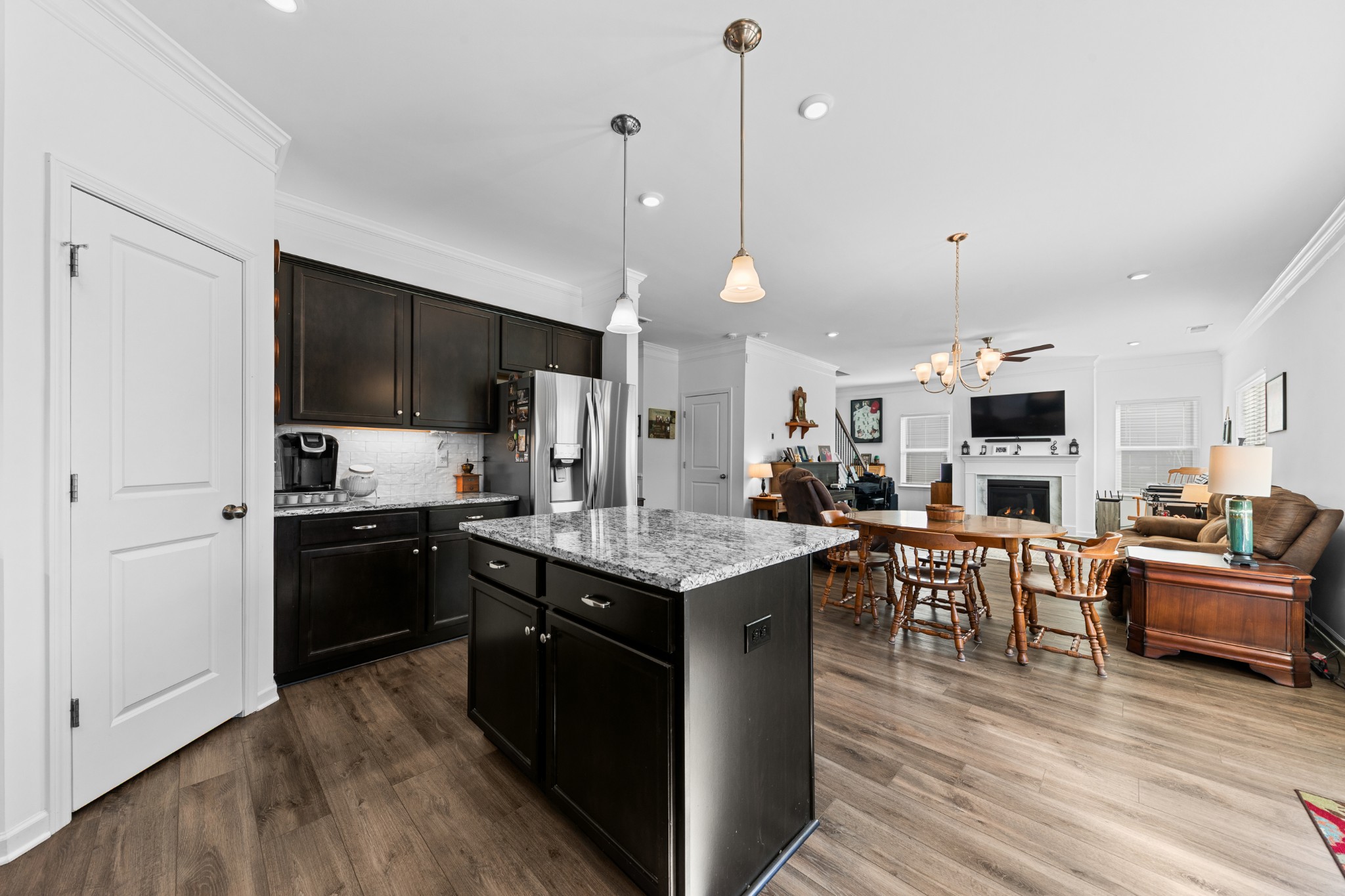 229 Stonewall Road Columbia, TN 38401 - Photo 19 of 61 a kitchen with stainless steel appliances kitchen island granite countertop a stove top oven a sink dishwasher a dining table and chairs with wooden floor