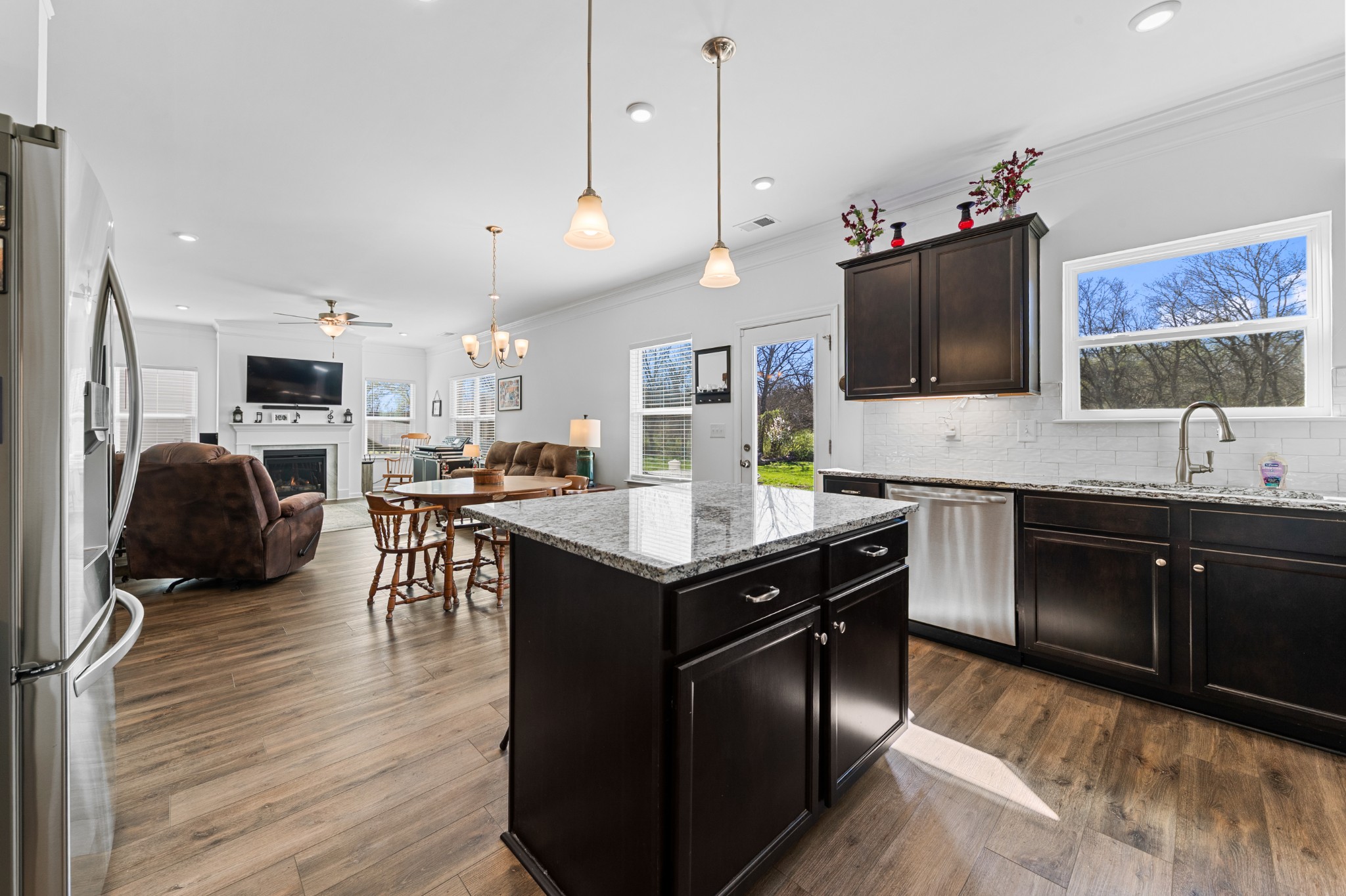 229 Stonewall Road Columbia, TN 38401 - Photo 20 of 61 a kitchen with stainless steel appliances granite countertop a sink a stove and a wooden floor