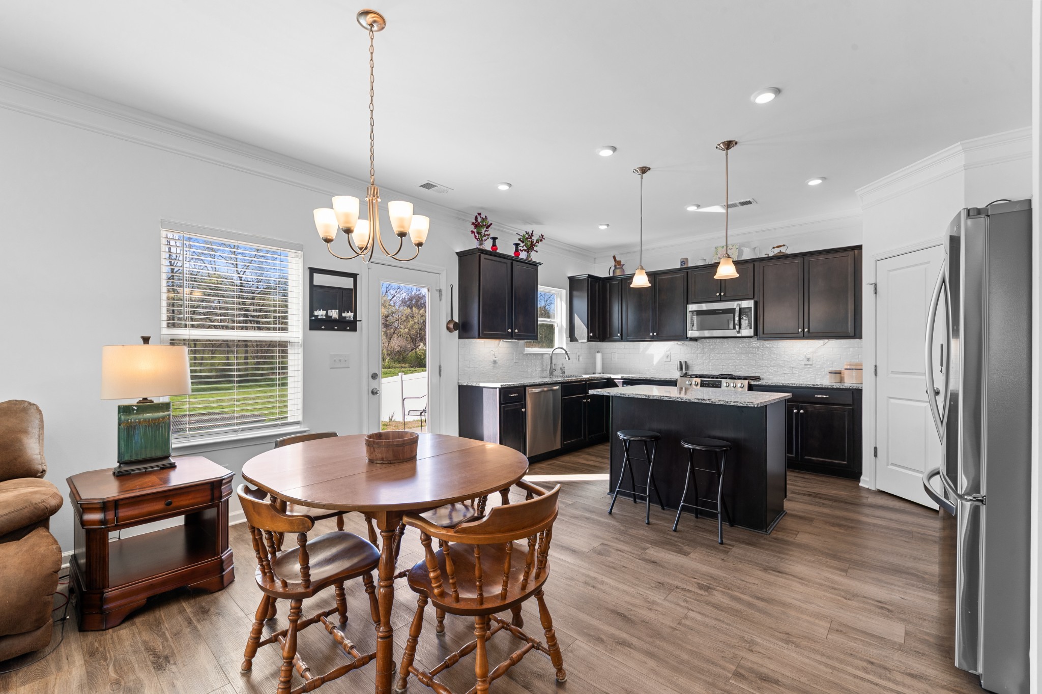 229 Stonewall Road Columbia, TN 38401 - Photo 24 of 61 a kitchen with a dining table chairs stainless steel appliances and cabinets