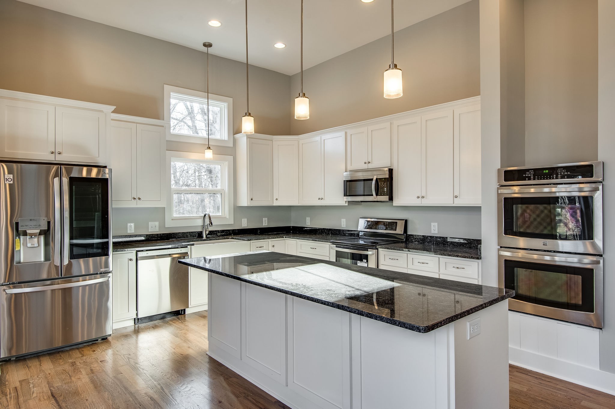 7936 Crow Cut Road Northwest Fairview, TN 37062 - Photo 10 of 36 VIEW OF KITCHEN FROM EAT IN AREA, DOUBLE OVENS, DISHWASHER, STOVE W/COOKTOP, MICROWAVE, AND FRIDGE. (pic from previous list)