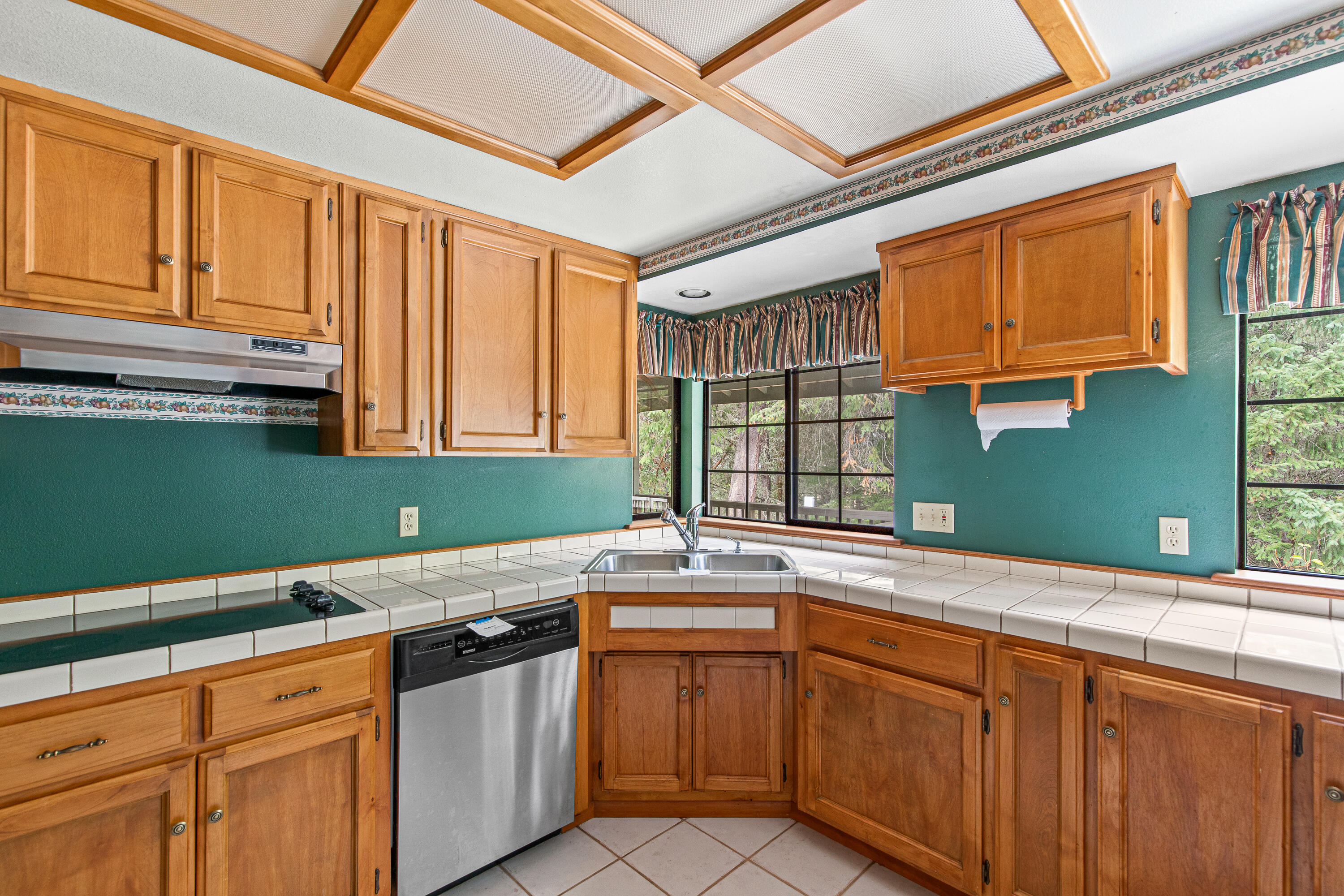 Kitchen with tile counters and floors