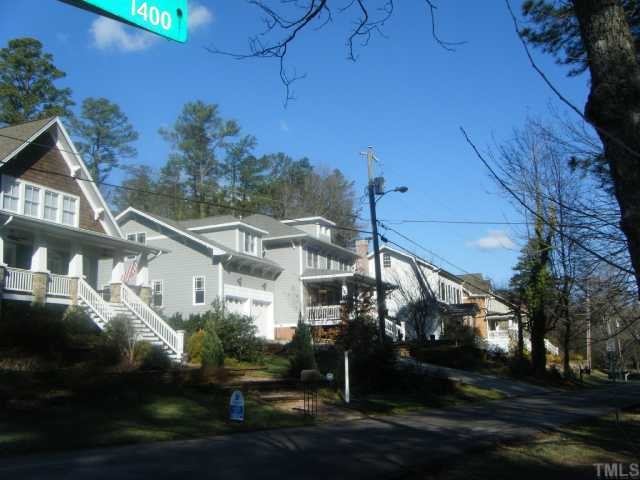 3030 Farrior Road, Unit 89 & 90 Raleigh, NC 27607 - Photo 4 of 4 a view of a white house next to a yard with big trees