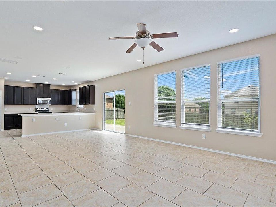 904 Lonesome Lilly Way Pflugerville, TX 78660 - Photo 6 of 34 The expansive living area features tile flooring, recessed lighting, and a ceiling fan