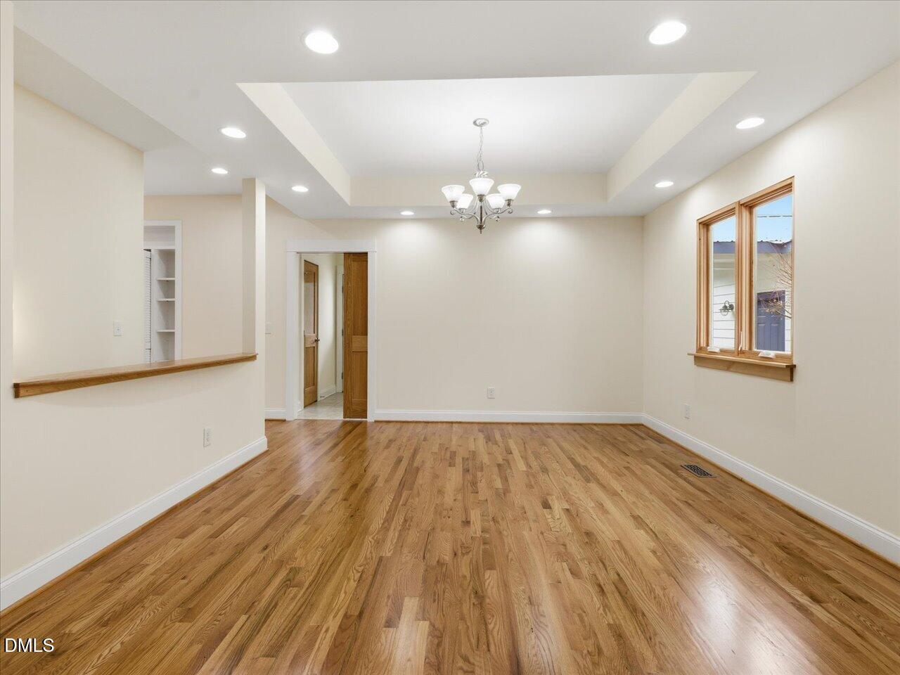 67 Bingham Ridge Drive Pittsboro, NC 27312 - Photo 13 of 82 a view of an empty room with wooden floor and a window
