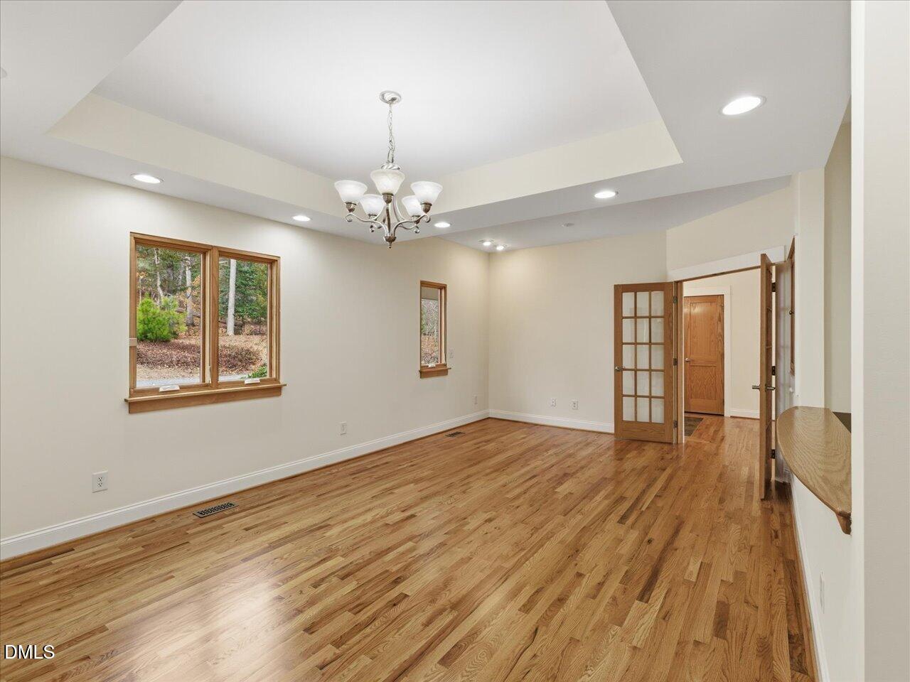 67 Bingham Ridge Drive Pittsboro, NC 27312 - Photo 14 of 82 a view of an empty room with wooden floor and a window