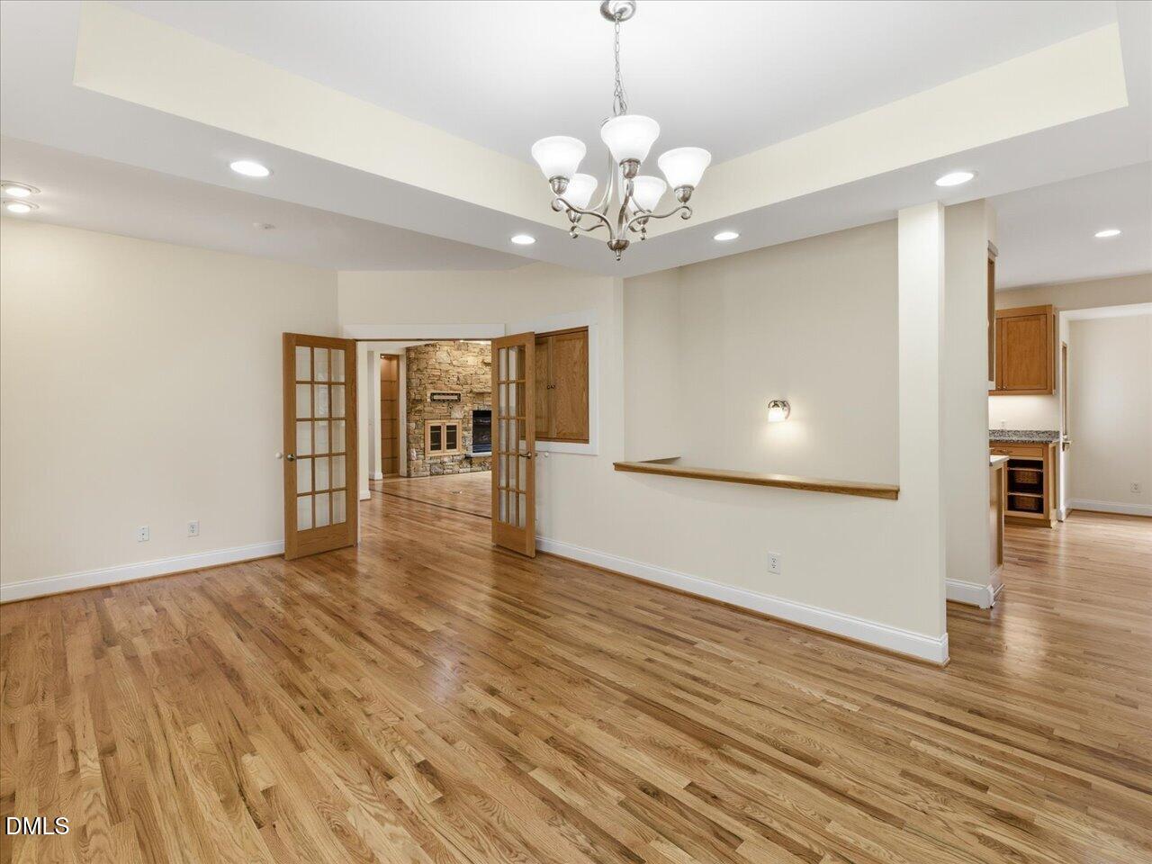 67 Bingham Ridge Drive Pittsboro, NC 27312 - Photo 15 of 82 a view of an empty room with wooden floor and a kitchen