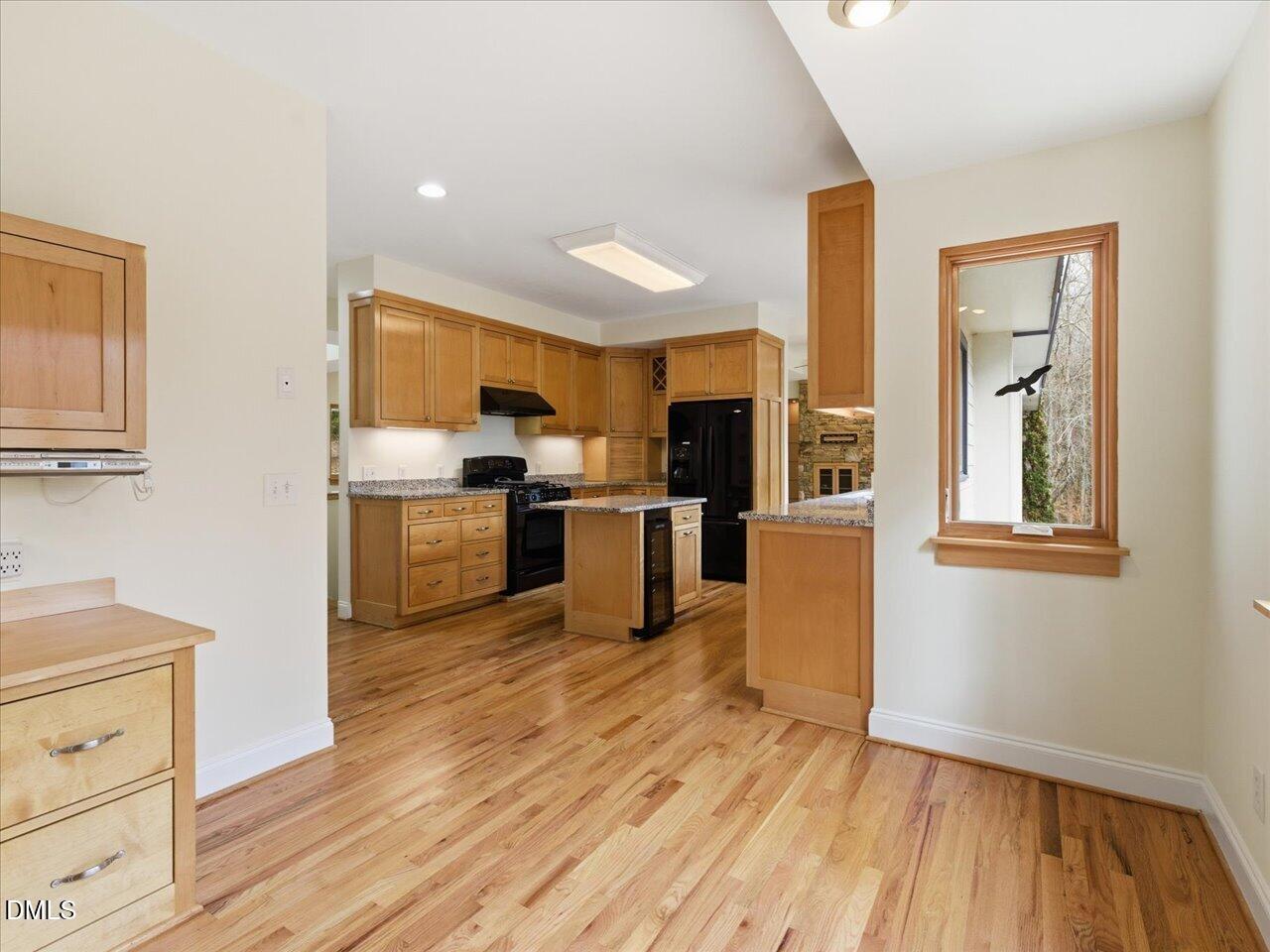 67 Bingham Ridge Drive Pittsboro, NC 27312 - Photo 22 of 82 a kitchen with stainless steel appliances a stove top oven a kitchen island a sink and a refrigerator