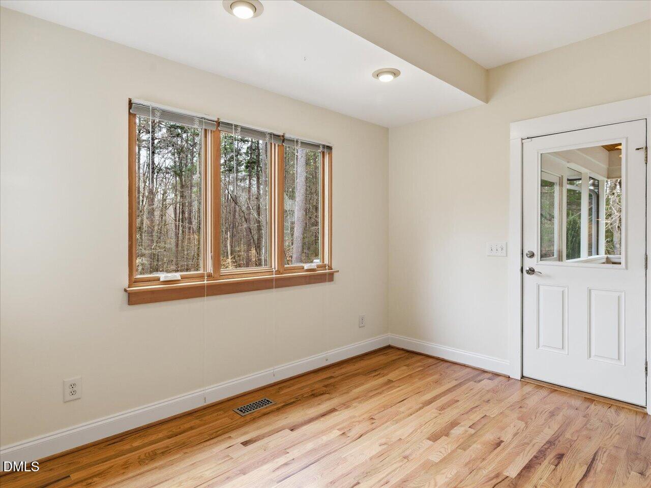 67 Bingham Ridge Drive Pittsboro, NC 27312 - Photo 23 of 82 a view of an empty room with wooden floor and a window