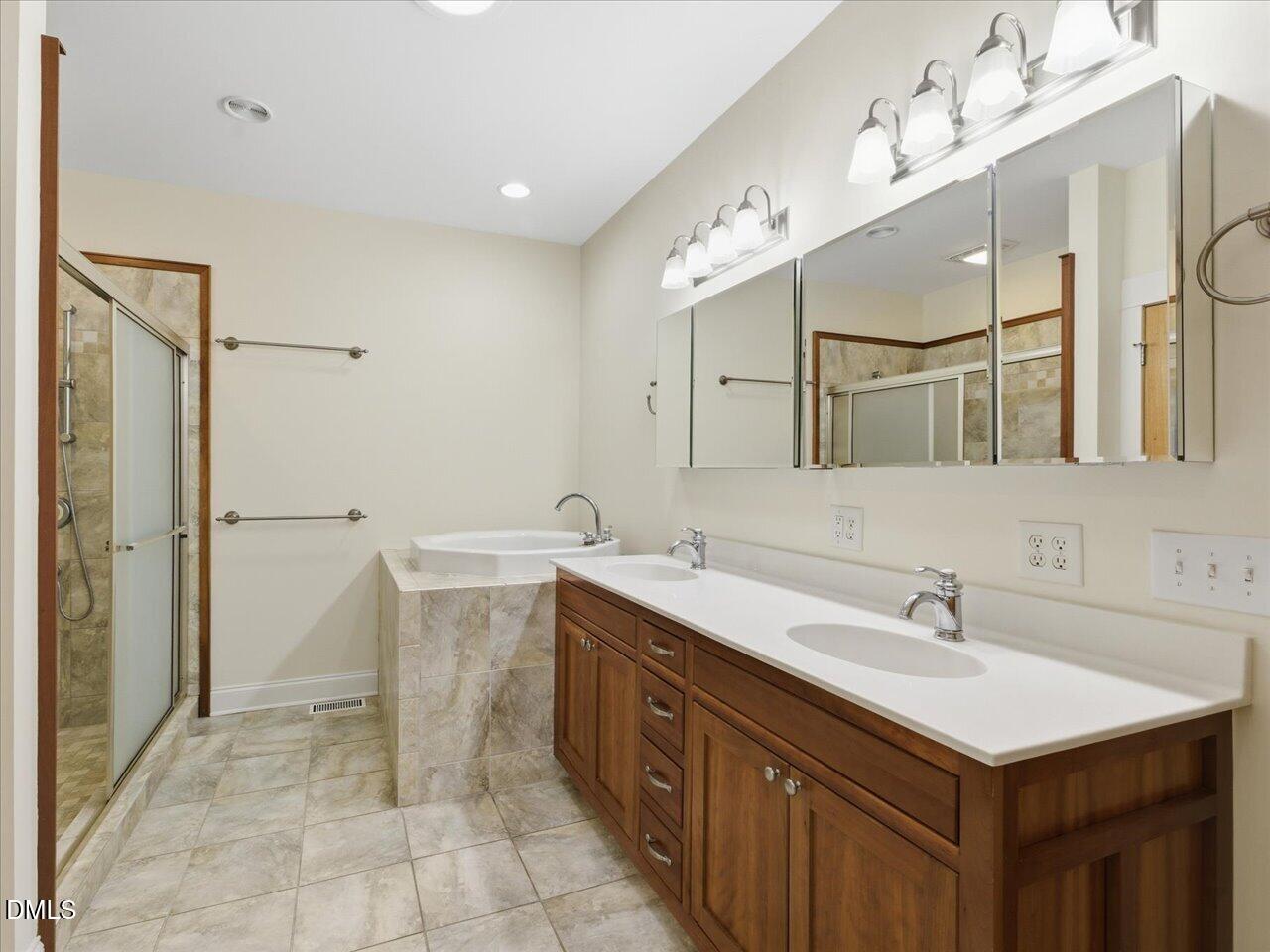 67 Bingham Ridge Drive Pittsboro, NC 27312 - Photo 40 of 82 a spacious bathroom with a sink double vanity and a mirror
