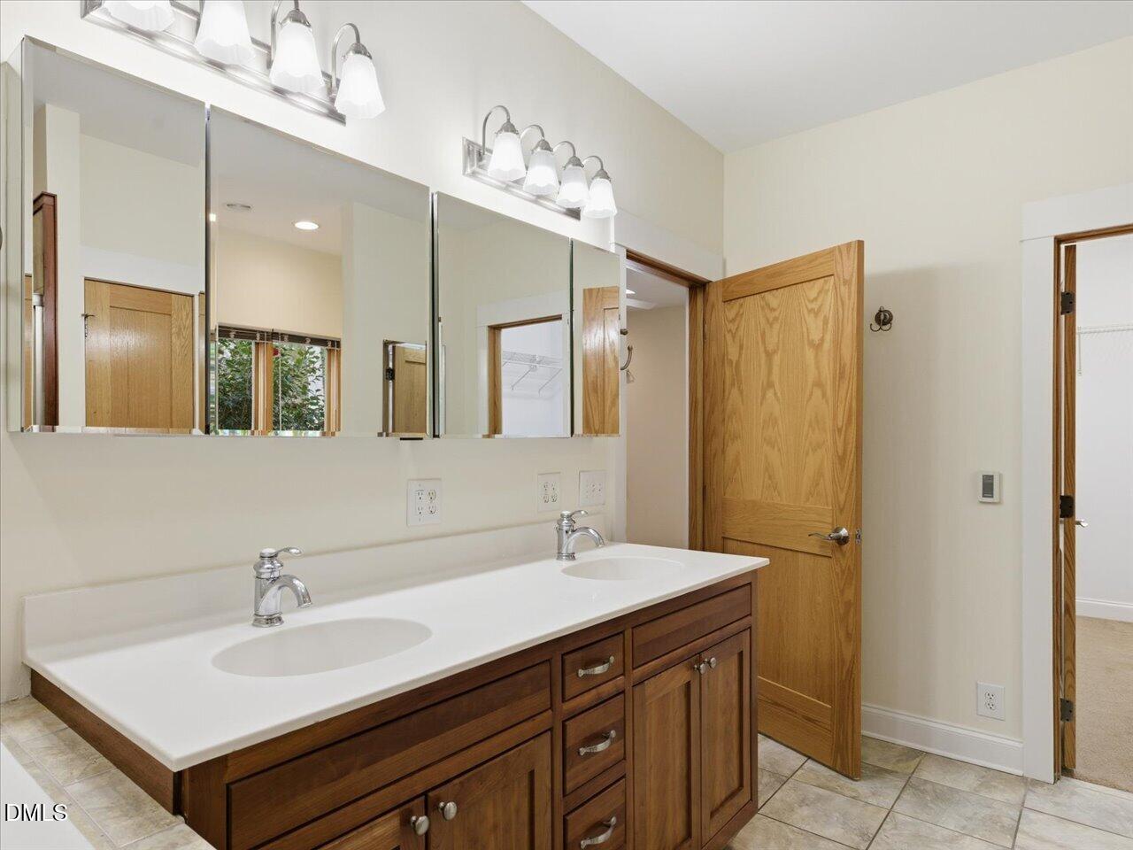 67 Bingham Ridge Drive Pittsboro, NC 27312 - Photo 41 of 82 a bathroom with a sink double vanity and a mirror