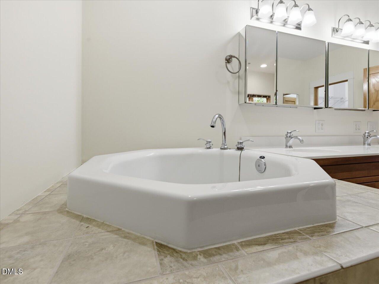 67 Bingham Ridge Drive Pittsboro, NC 27312 - Photo 42 of 82 a white bath tub sitting in a bathroom