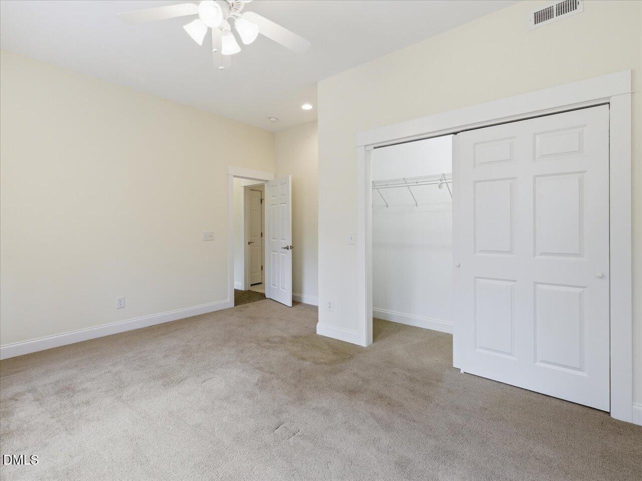 67 Bingham Ridge Drive Pittsboro, NC 27312 - Photo 59 of 82 an empty room with a chandelier fan