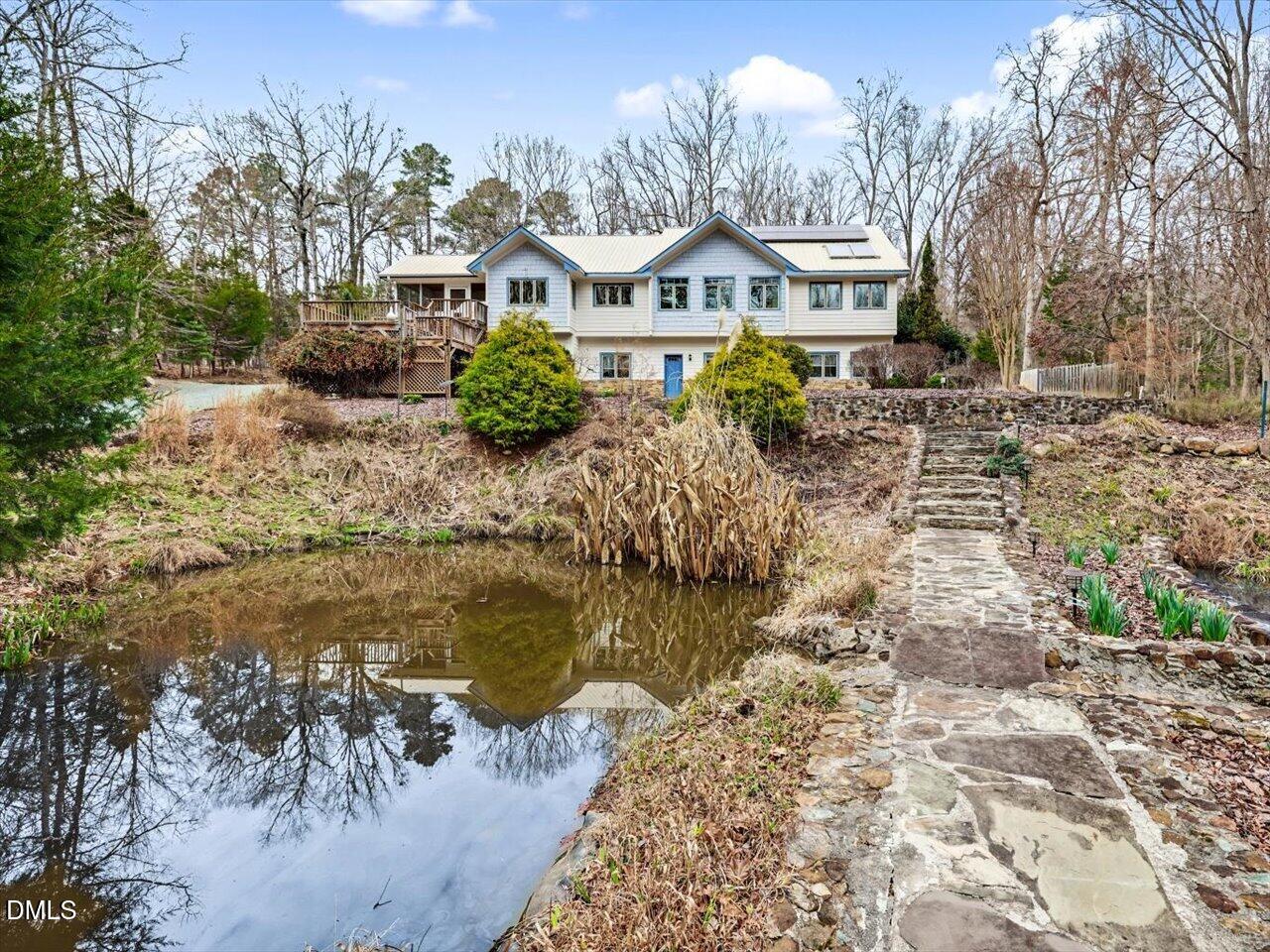 67 Bingham Ridge Drive Pittsboro, NC 27312 - Photo 70 of 82 a front view of a house with a yard and mountain view in back