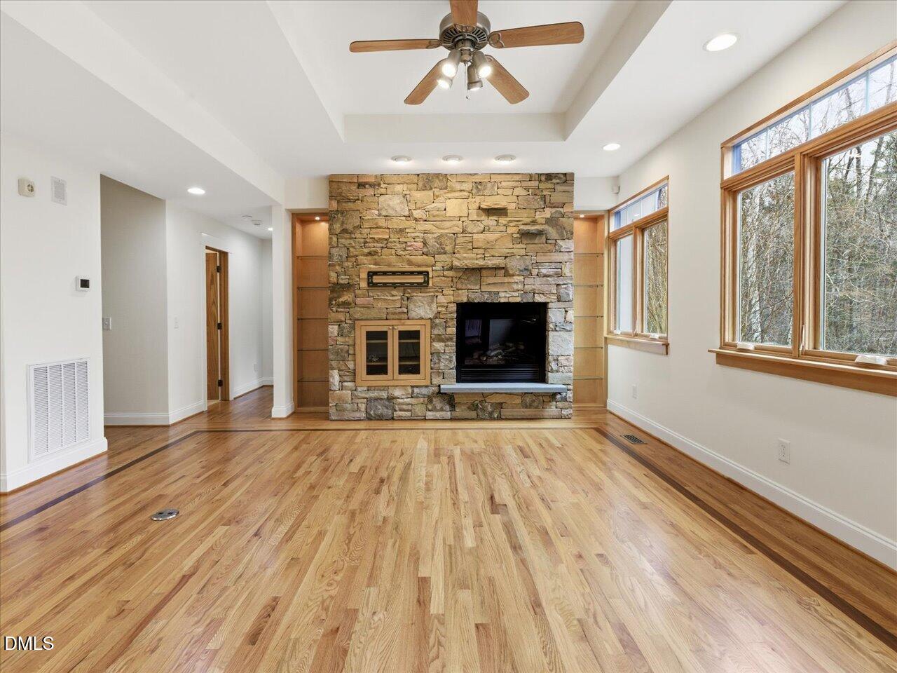 67 Bingham Ridge Drive Pittsboro, NC 27312 - Photo 8 of 82 wooden floor fireplace and windows in an empty room