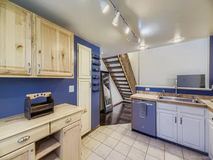 a kitchen that has a sink and cabinets