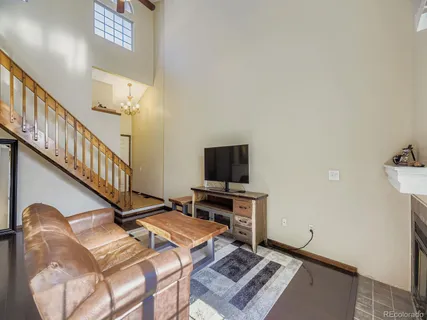 a living room with hard wood flooring and a flat screen tv