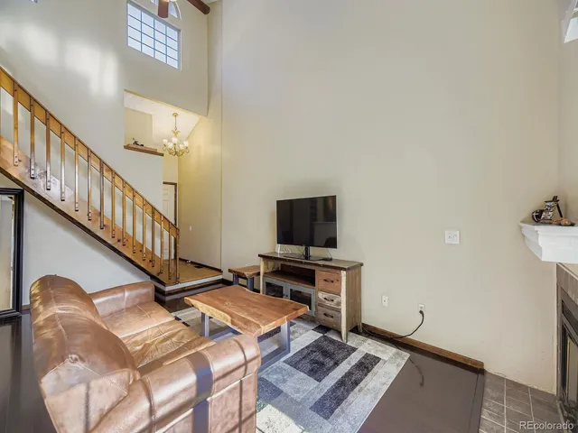 a living room with hard wood flooring and a flat screen tv