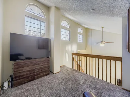 a view of hall way with furniture and window