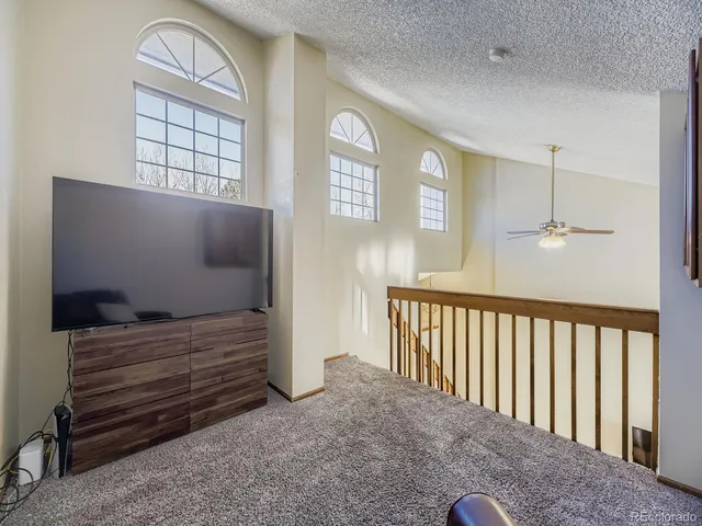 a view of hall way with furniture and window