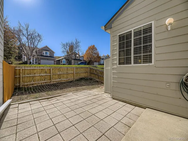 a view of a brick house with a large window