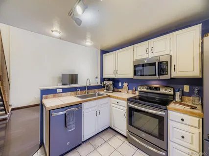a kitchen with stainless steel appliances a stove microwave and cabinets