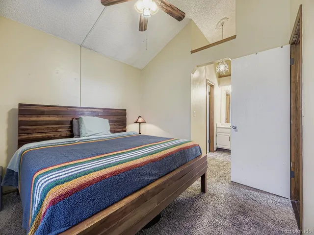 a bedroom with bed and wooden floor