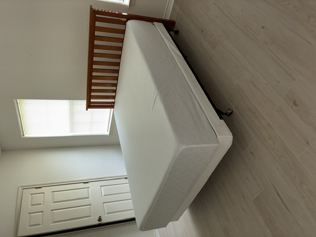404 West 24th Street Bryan, TX 77803 - Photo 15 of 22 a bed sitting in a bedroom next to a window