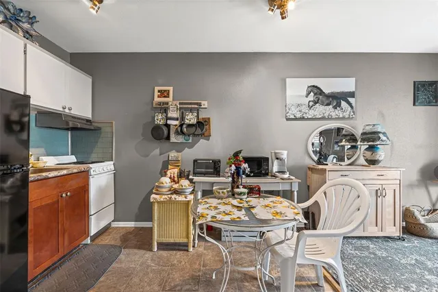a dining room with furniture a rug and a window