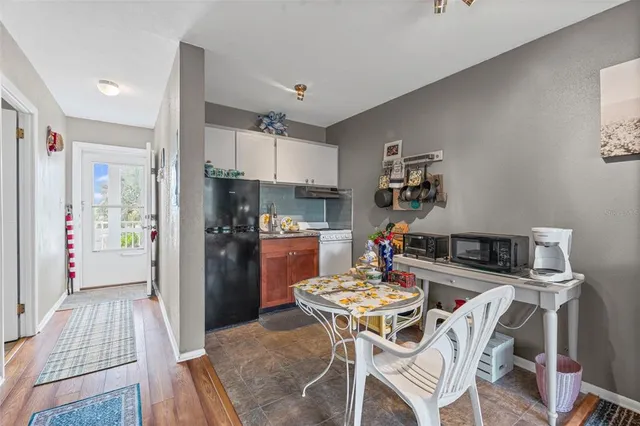 a kitchen with a table and chairs in it