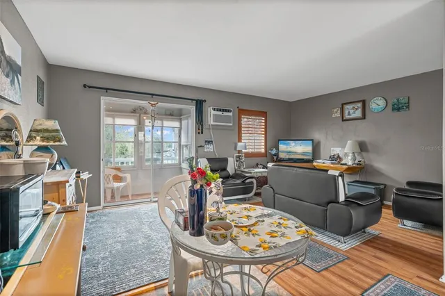 a living room with furniture a flat screen tv and a table