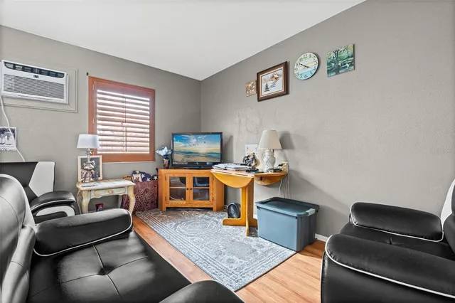 a bedroom with furniture and a flat screen tv